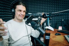 Smiling talking radio presenter in radio studio royalty free stock photography Smiling talking radio presenter in radio studio royalty free stock photography