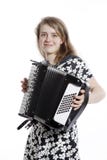 Smiling teenage girl stands in studio with accordion stock photo Smiling teenage girl stands in studio with accordion stock photo