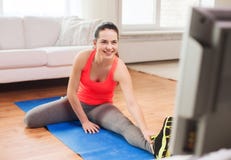 Smiling teenage girl streching on floor at home Royalty Free Stock Photography Smiling teenage girl streching on floor at home Royalty Free Stock Photography