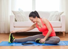 Smiling teenage girl streching on floor at home Stock Photography Smiling teenage girl streching on floor at home Stock Photography