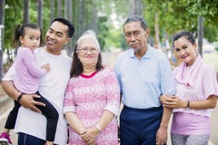Smiling three generation family looks at the camera stock photos Smiling three generation family looks at the camera stock photos