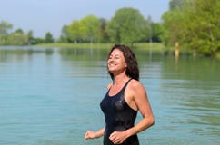 https://thumbs.dreamstime.com/t/smiling-woman-bathing-suit-wading-lake-beautiful-single-joyous-smile-shallow-green-trees-background-71511622.jpg