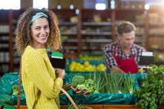 Smiling woman buying vegetables in organic section stock photography Smiling woman buying vegetables in organic section stock photography