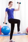 Smiling woman exercising using dumbbells royalty free stock images Smiling woman exercising using dumbbells royalty free stock images