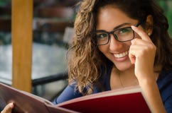 A smiling woman in a restaurant with the menu in hands royalty free stock images A smiling woman in a restaurant with the menu in hands royalty free stock images
