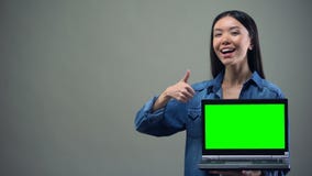 Smiling woman showing thumbs-up holding green screen laptop, online education stock video Smiling woman showing thumbs-up holding green screen laptop, online education stock video