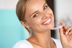 Smiling Woman With White Teeth Holding Teeth Whitening Tray