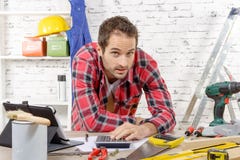 Smiling young carpenter in his workshop royalty free stock photography Smiling young carpenter in his workshop royalty free stock photography
