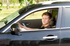 Smiling Young Man Driving A Car Stock Photos