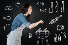 Smiling Young Woman Adding Spices While Making Barbeque Royalty Free Stock Images