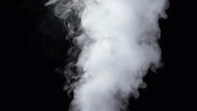 Smoke billowing over steady flow on isolated black studio background