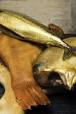Smoked fish, mackerel, sig, perch and cod roe on the black wooden table. Omega 3 source. Polyunsaturated fats Stock Photo Smoked fish, mackerel, sig, perch and cod roe on the black wooden table. Omega 3 source. Polyunsaturated fats Stock Photo