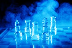 Smoking Chess. Blue light glass chess with some smoke in the background stock photos Smoking Chess. Blue light glass chess with some smoke in the background stock photos