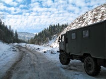 Snow covered mountain road in winter with truck royalty free stock photos Snow covered mountain road in winter with truck royalty free stock photos