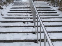 Snow covered stairs with stainless steel banister stock image Snow covered stairs with stainless steel banister stock image