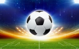 Soccer ball above green football stadium at night stock images Soccer ball above green football stadium at night stock images