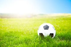 Soccer ball or football ball on ground and green field of grass Stock Image Soccer ball or football ball on ground and green field of grass Stock Image