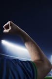 Soccer player flexing bicep in a stadium at night time royalty free stock image Soccer player flexing bicep in a stadium at night time royalty free stock image