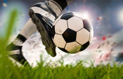 Soccer player kicking soccer ball in motion
