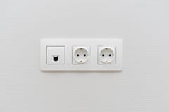 A socket on a light wall, a multifunction outlet with an internet connection, two European-style outlets royalty free stock image A socket on a light wall, a multifunction outlet with an internet connection, two European-style outlets royalty free stock image