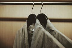 Soft focus at two robe hanging on the rack in wardrobe stock image Soft focus at two robe hanging on the rack in wardrobe stock image