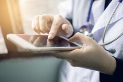 Soft focus of woman doctor hand holding and touching blank screen for work on modern smart phone in the consultation stock photo Soft focus of woman doctor hand holding and touching blank screen for work on modern smart phone in the consultation stock photo