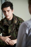 Soldier Suffering With Stress Talking To Counselor stock image Soldier Suffering With Stress Talking To Counselor stock image