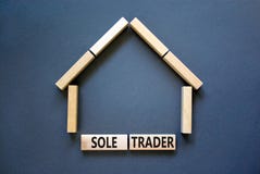 Sole trader symbol. Concept words `Sole trader` on wooden blocks near miniature wooden house. Beautiful grey background. Busines