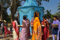 Some men and women performing puja rituals by walking round the temple and distributing sweets to the children royalty free stock photos Some men and women performing puja rituals by walking round the temple and distributing sweets to the children royalty free stock photos