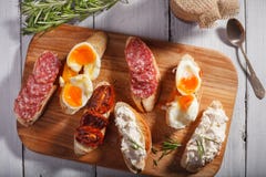 Some sandwiches on white wood background. Some tasty sandwiches on wood background. Top view stock images Some sandwiches on white wood background. Some tasty sandwiches on wood background. Top view stock images