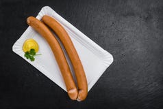 Some Sausages Frankfurter on a dark slate slab. Sausages Frankfurter on a vintage slate slab close-up shot; selective focus royalty free stock photography Some Sausages Frankfurter on a dark slate slab. Sausages Frankfurter on a vintage slate slab close-up shot; selective focus royalty free stock photography