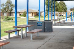 some seating benches and the barbecue equipment in a public park