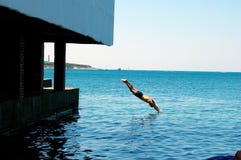 Sommardag på havet, dykar för en man från pir in i havet arkivfoto Sommardag på havet, dykar för en man från pir in i havet arkivfoto