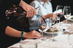 Sommelier Pouring Champagne Into Glass At Wine Tasting Stock Photos Sommelier Pouring Champagne Into Glass At Wine Tasting Stock Photos