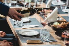 Sommelier pouring red wine into glass at wine tasting stock images Sommelier pouring red wine into glass at wine tasting stock images