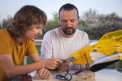 Son and father made homemade radio-controlled model aircraft ai stock photography Son and father made homemade radio-controlled model aircraft ai stock photography