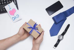 Son gives a gift to dad. Father`s Day. royalty free stock image Son gives a gift to dad. Father`s Day. royalty free stock image