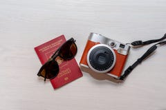 Sonnenbrille mit dem Pass eines Bürgers der Russischen Föderation und einer sofortigen Fotokamera auf einem weißen hölzernen Hint lizenzfreies stockbild Sonnenbrille mit dem Pass eines Bürgers der Russischen Föderation und einer sofortigen Fotokamera auf einem weißen hölzernen Hint lizenzfreies stockbild