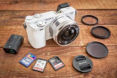 Sony A6000 mirrorless digital camera. FORT COLLINS, CO, USA, April 17, 2015: Sony A6000 mirrorless digital camera with a set of filters, memory cards, lens cap stock image Sony A6000 mirrorless digital camera. FORT COLLINS, CO, USA, April 17, 2015: Sony A6000 mirrorless digital camera with a set of filters, memory cards, lens cap stock image