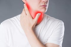 Sore throat, men with pain in neck, studio shot on gray background royalty free stock image Sore throat, men with pain in neck, studio shot on gray background royalty free stock image
