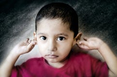 Sorry Child Holding Ears Stock Photo