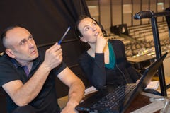 Sound engineer working at mixing panel with aprentice royalty free stock images Sound engineer working at mixing panel with aprentice royalty free stock images
