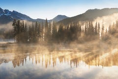 South Sister and Broken Top reflect over the calm waters of Sparks Lake at sunrise in the Cascades Range in Central Oregon, USA in royalty free stock photo South Sister and Broken Top reflect over the calm waters of Sparks Lake at sunrise in the Cascades Range in Central Oregon, USA in royalty free stock photo