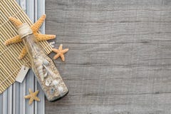 Souvenir bottle with sand and seashells on wooden background stock images Souvenir bottle with sand and seashells on wooden background stock images