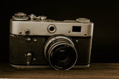 sovjetisk kamera f?r gammal tappning med linsen p? tr?bakgrund royaltyfri fotografi sovjetisk kamera f?r gammal tappning med linsen p? tr?bakgrund royaltyfri fotografi