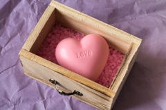 Spa And Wellness Concept: Wooden Box With Pink Sea Salt And Heart Shape Soap With Word `love` On It Stock Images
