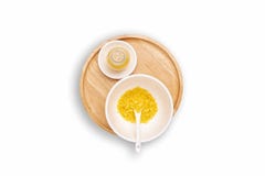 Spa salt in bottles. Spa salt, yellow-orange in the cup with a spoon setting isolated on white background. Aromatic sea salts, royalty free stock images Spa salt in bottles. Spa salt, yellow-orange in the cup with a spoon setting isolated on white background. Aromatic sea salts, royalty free stock images