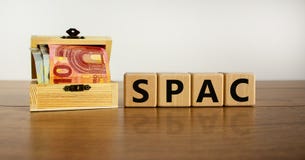 SPAC, special purpose acquisition company symbol. Wooden cubes with word `SPAC` on beautiful white background, copy space. Euro