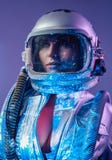 Spacewoman in helmet with open costume in starlight