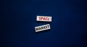 SPACs market symbol. Wooden blocks with words `SPACs, special purpose acquisition companies market` on beautiful black backgroun